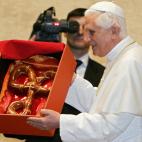 Vatican City, VATICAN CITY STATE: Pope Benedict XVI holds a gift during during a special audience for an Austrian delegation at the Vatican, 17 December 2005. The Christmas tree, a donation from Austria, will later be lit on St-Peter's square. ...