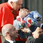 VATICAN CITY, Vatican: Pope Benedict XVI kisses a baby on St-Peter square at the Vatican during his weekly general audience, 14 December 2005. AFP PHOTO / ANDREAS SOLARO (Photo credit should read ANDREAS SOLARO/AFP/Getty Images)