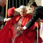 Vatican City, VATICAN CITY STATE: Pope Benedict XVI is helped by his private secretary Georg Gaenswein (R) and bishop James Harvey prior his weekly general audience in St. Peter's Square at the Vatican 23 November 2005. The Vatican relaced 22 N...