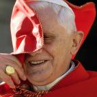 Vatican City, VATICAN CITY STATE: Pope Benedict XVI smiles as the wind blows his red coat during his weekly general audience in St. Peter's Square at the Vatican 23 November 2005. The Vatican relaced 22 November a document reading that men with...