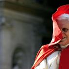 Vatican City, VATICAN CITY STATE: Pope Benedict XVI smiles as the wind blows his red cape during his weekly general audience in St. Peter's Square at the Vatican 23 November 2005. The Vatican relaced 22 November a document reading that men with...