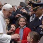 ROME, Italy: Pope Benedict XVI is greeted by a crowd of people as he leaves his residence 20 April 2005 in Rome. Newly elected Pope Benedict XVI made his first trip outside the Vatican, to his former apartment in Rome where he was greeted by we...