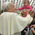 Pope Francis holds up a baby upon his arrival for the weekly general audience in the Pope Paul VI hall, at the Vatican, Wednesday, Feb. 4, 2015. (AP Photo/L'Osservatore Romano, pool)