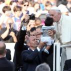 VATICAN CITY, VATICAN - JUNE 14:  Pope Francis greets a baby as he arrives in St. Peter's Square for a meeting with the Roman Diocesans on June 14, 2015 in Vatican City, Vatican. The Pontiff invited everyone to pay attention to environmental iss...