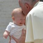 Pope Francis blesses a baby during his weekly general audience at St Peter's square on June 17, 2015 at the Vatican. AFP PHOTO / ALBERTO PIZZOLI (Photo credit should read ALBERTO PIZZOLI/AFP/Getty Images)