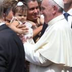 SANTIAGO DE CUBA, CUBA - SEPTEMBER 22: Pope Francis holds a baby as he leaves the cathedral after holding a mass and blessing the city on September 22, 2015 in Santiago de Cuba, Cuba. Pope Francis leaves for the United States after spending fou...