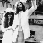 Beatle John Lennon waves his marriage certificate as his bride, Japanese artist Yoko Ono, stands at his side after their wedding at the Rock of Gibraltar. They are about to board a chartered jet to Paris where they will honeymoon.
