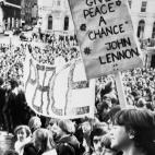 The title of John Lennon's anti-war anthem "Give Peace a Chance" on a placard outside St George's City Hall in Liverpool when thousands gathered to pay tribute to the former Beatle, 1980.
