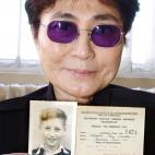 Musician and artist Yoko Ono, widow of Beatles singer John Lennon, holds aloft a picture of her late husband, when he was a youngster in Liverpool.