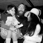 John Lennon, holds Kyoko Cox, the 6 year old daughter of his Japanese wife, Yoko Ono, on the child's arrival at Heathrow airport, where she had flown in from New York.