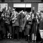 15 year old Michael Lowbey, of Sidcup, Kent, gives his own impromptu concert outside the Odean, Lewisham, where thousands of teenagers wait for the box office to open so they can buy tickets to the forthcoming Beatles concert.