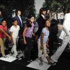 School children pose with wax figures representing The Beatles, from left, George Harrison, Paul McCartney, Ringo Starr and John Lennon are unveiled at Madame Tussauds New York, Thursday June 14, 2012, in New York. (Photo by Evan Agostini/Invisi...