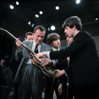 FILE - In this Feb. 9, 1964. file photo Paul McCartney, right, shows his bass guitar to Ed Sullivan before the Beatles' live television appearance on "The Ed Sullivan Show" in New York along with John Lennon, center, and Ringo Starr, behind McCa...