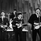 FILE - In this Feb. 9, 1964 file photo, The Beatles perform on the CBS "Ed Sullivan Show" in New York. Ringo Starr plays drums, rear, and playing guitars from left are Paul McCartney, George Harrison and John Lennon. An estimated 73 million Amer...