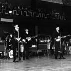 Pop group The Beatles, left to right Ringo Starr on drums, Paul McCartney, George Harrison and John Lennon on electric guitars, performing in a large dance hall during a Royal Variety performance in London, England on December 3, 1963. (Photo by...