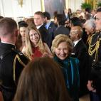 Former U.S. secretary of state Hillary Clinton (R), her daughter Chelsea Clinton (2nd R) and Clinton personal aide Huma Abedin (behind) make their way from the East Room following the Medal of Freedom presentation ceremony at the White House on ...