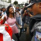 Una mujer afroecuatoriana discute con los agentes frente a la Asamblea Nacional en Quito el 5 de mayo de 2010 durante una protesta contra la propuesta de ley de privatizar las aguas, algo que afectaría negativamente a la población indígena de...