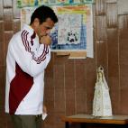 Opposition presidential candidate Henrique Capriles gestures to a statue of the Virgin Mary before casting his ballot for the presidential election at a polling station in Caracas, Venezuela, Sunday, April 14, 2013. Capriles is running for presi...