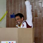 Opposition presidential candidate Henrique Capriles shows his ballot as he votes in the presidential election at a polling station in Caracas, Venezuela, Sunday, April 14, 2013. Capriles is running for president against Nicolas Maduro, the hand ...