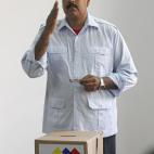 Venezuela's interim President Nicolas Maduro gestures before placing his ballot in a box during the presidential election in Caracas, Venezuela, Sunday, April 14, 2013. Maduro, who served as late President Hugo Chavez's foreign minister and vice...
