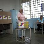 A woman casts her ballot for the presidential election in Caracas, Venezuela, early Sunday, April 14, 2013. Interim President Nicolas Maduro, who served as late President Hugo Chavez's foreign minister and vice president, is running against oppo...