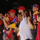 Venezuela's acting President Nicolas Maduro stands surrounded by his family during his closing campaign rally in Caracas, Venezuela, Thursday April 11, 2013. Maduro, the hand-picked successor of Venezuela's late President Hugo Chavez, is running...