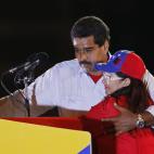 Venezuela's acting President Nicolas Maduro holds his wife Cilia Flores during his closing campaign rally in Caracas, Venezuela, Thursday, April 11, 2013. Maduro, the hand-picked successor of Venezuela's late President Hugo Chavez, is running fo...