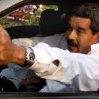 Venezuela's interim President Nicolas Maduro gives a thumbs up as Argentina's soccer legend Diego Armando Maradona sits behind him as they leave after paying their respects at the tomb of late President Hugo Chavez in Caracas, Venezuela, Friday,...