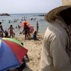 Residents enjoy a day at the beach in La Guaira, some 37 miles north of Caracas, Venezuela, Saturday, April 13, 2013. Just over a month after Hugo Chavez succumbed to cancer, Venezuelans vote Sunday to replace the late president who built a near...