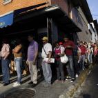 Residents wait in line to enter a polling station to vote in the presidential election in Caracas, Venezuela, early Sunday, April 14, 2013. Interim President Nicolas Maduro, who served as the late President Hugo Chavez's foreign minister and vic...
