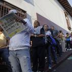 Residents wait in line to enter a polling station during the presidential election in Caracas, Venezuela, early Sunday, April 14, 2013. Interim President Nicolas Maduro, who served as the late President Hugo Chavez's foreign minister and vice pr...