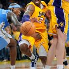 Lakers Kobe Bryant squeezes by Nuggets Al Harrington and Pau Gasol while dribbling at the Staples Center Saturday.  (Photo by Wally Skalij/Los Angeles Times via Getty Images)