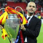 Barcelona's Spanish coach Josep Guardiola celebrates with the trophy at the end of the UEFA Champions League final football match FC Barcelona vs. Manchester United, on May 28, 2011 at Wembley stadium in London.Barcelona won 3 to 1. AFP PHOTO / ...