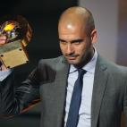 FC Barcelona's Spanish coach Josep Guardiola poses after receiving the FIFA Men's Football Coach of the year award during the FIFA ballon d'or ceremony on January 9, 2012 at the Kongresshaus in Zurich. AFP PHOTO / FRANCK FIFE (Photo credit sh...
