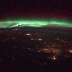 "Tonight's finale: Northern Lights - recent aurora in green and red waves, USA and Canada below, the universe above."