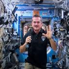 Canadian astronaut Chris Hadfield waves goodbye at the end of a news conference from the International Space Station on a photograph taken from a television monitor Thursday, Jan. 10, 2013 in St-Hubert, Quebec, Canada. Hadfield is on a five-mont...