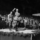 19th December 1934: German chancellor Adolf Hitler salutes a crowd of 60,000 at a Hitler Youth rally at Nuremberg. (Photo by Central Press/Getty Images)
