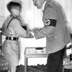 A picture dated 1936 shows German Chancellor and nazi dictator Adolf Hitler shaking hands with young Harald Quandt (1921-1967) in his uniform of the Hitlerian Youth Movement. Harald Quandt was Magda Goebbels' son from her first marriage with ind...
