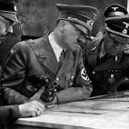 A picture dated 1939 shows German Nazi Chancellor and dictator Adolf Hitler (C) consulting a geographical survey map with his general staff including Heinrich Himmler (L) and Martin Bormann (R) at an unlocated place during World War II. AFP PHOT...