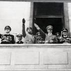 BERLIN, GERMANY - MAY 1: German Nazi leader Adolf Hitler (3rd R) gives a Heil Hitler salute to the crowd from a balcony with German Foreign minister Joachim von Ribbentrop (L), Italian Foreign minister Galeazzo Ciano (2nd L), Commander of the L...