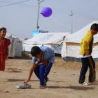 Un grupo de niños juega en un campo de refugiados en Irak