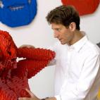 Lego artist Nathan Sawaya with one of his creations in Art Of The Brick.