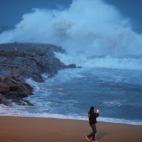 Man takes pictures of the storm &quot;Gloria&quot; on Barceloneta beach, in Barcelona