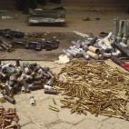 Weapons and ammunition along with police uniforms and bulletproof vests recovered from suspected Boko Haram sect members, put on display in Bukavu Barracks in Kano, Nigeria, Wednesday, March. 21, 2012. (AP Photos/Salisu Rabiu)