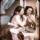Una mujer semidesnuda, con el pecho al descubierto y con un collar de perlas, se mira en el espejo. Daguerrotipo estereoscópico coloreado a mano. 1850.
