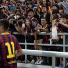 FC Barcelona's Neymar (front) is cheered by his fans as he enter the pitch to play their exhibition match against Thailand's national football team at the Rajamangala football stadium in Bangkok on August 7, 2013. AFP PHOTO/ Nicolas ASFOURI ...