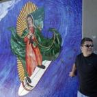 The image of the Virgin of Guadalupe on a surfboard is a popular attraction in Encinitas, Calif. was installed recently by disguised artists under a train bridge.