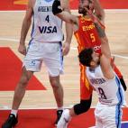 Spain's Rudy Fernandez (top R) takes a shot as Argentina's Luis Scola watches during the Basketball World Cup final game between Argentina and Spain in Beijing on September 15, 2019. (Photo by NOEL CELIS / AFP) (Photo credit should read N...
