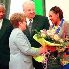 La hija del líder sudafricano recibe un ramo de flores de la mujer de Boris Yeltsin. Zenani Mandela-Dlamini acompañó a su padre a Rusia en 1999.