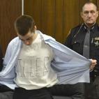 TJ Lane se quita la camisa para mostrar la palabra "killer" ("asesino") escrita en su camiseta durante su juicio en Cleveland, Ohio, el 19 de marzo. Lane fue condenado a cadena perpetua por el asesinato de tres estudiantes.
